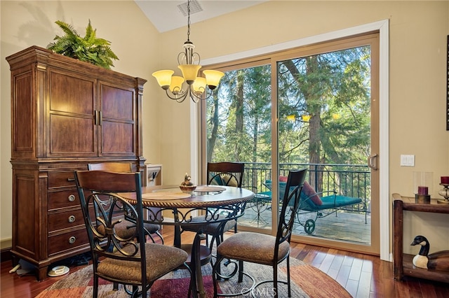 dining room featuring a notable chandelier, vaulted ceiling, and dark wood-type flooring