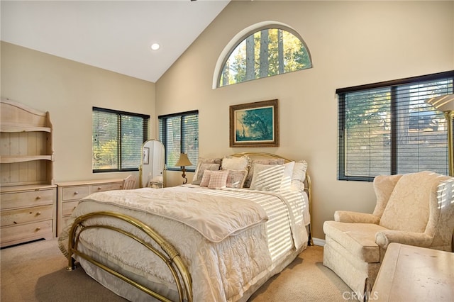 carpeted bedroom featuring high vaulted ceiling