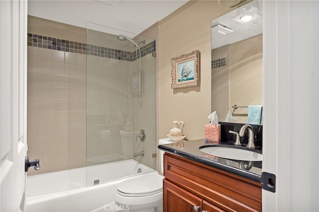 full bathroom with tiled shower / bath combo, vanity, and toilet