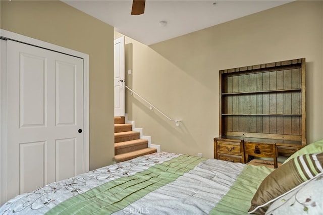 bedroom featuring ceiling fan and a closet