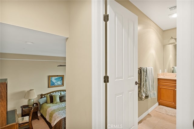 bedroom featuring light tile patterned floors and sink