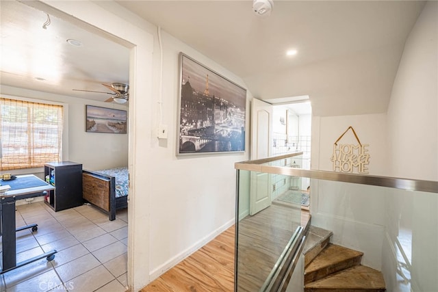 corridor featuring lofted ceiling and light hardwood / wood-style flooring