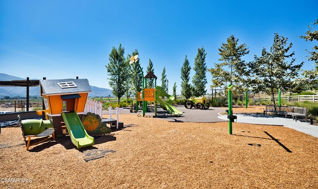 view of jungle gym featuring a mountain view