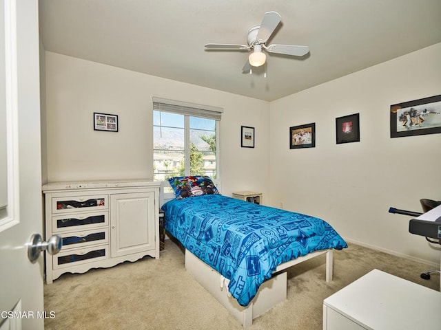 bedroom featuring ceiling fan and light colored carpet