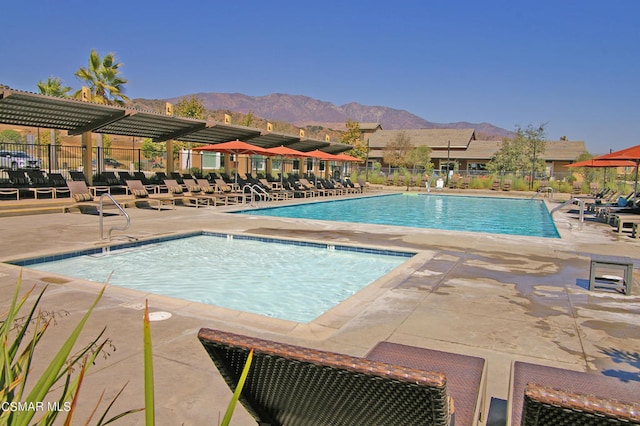 view of pool with a mountain view and a patio area