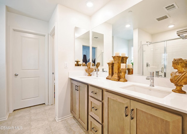 bathroom with vanity, tile patterned flooring, and an enclosed shower