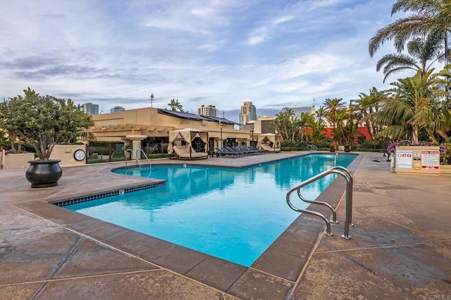 view of pool with a pergola and a patio area