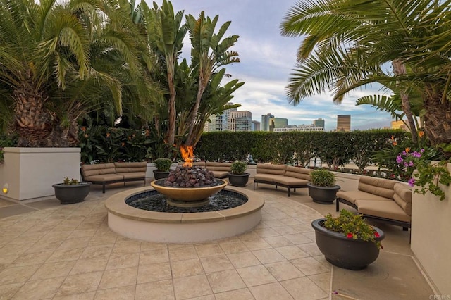 view of patio with an outdoor living space with a fire pit