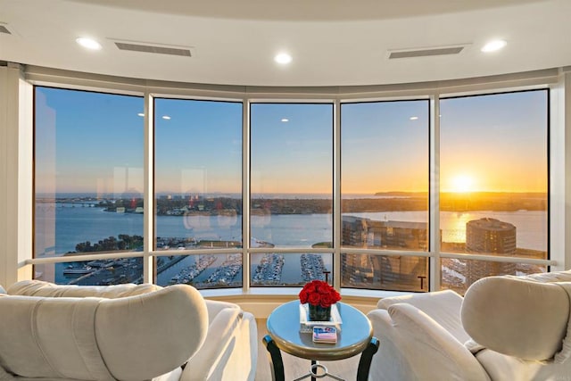 living room featuring expansive windows and a water view