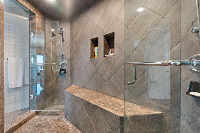 bathroom with a shower with door