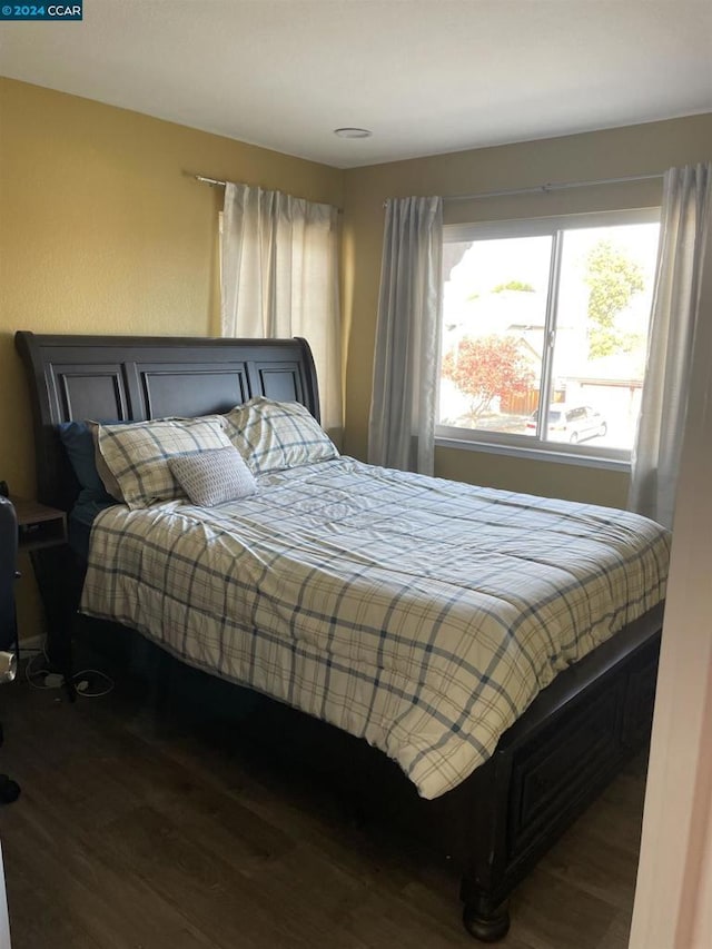 bedroom featuring dark hardwood / wood-style flooring