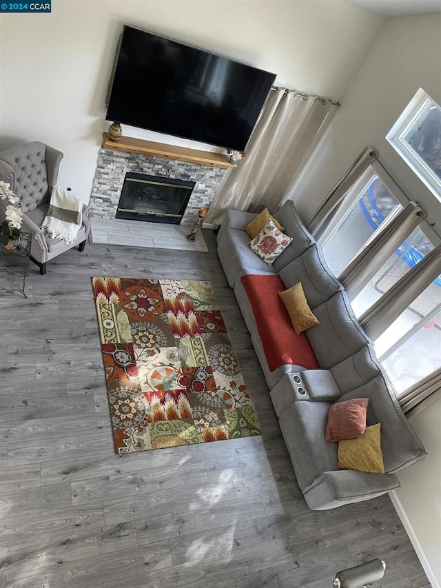 unfurnished living room featuring a fireplace, hardwood / wood-style flooring, and vaulted ceiling