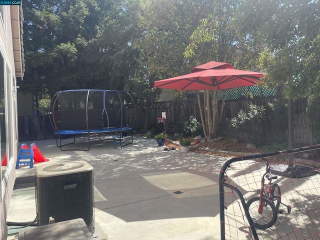 view of patio featuring a trampoline and central air condition unit