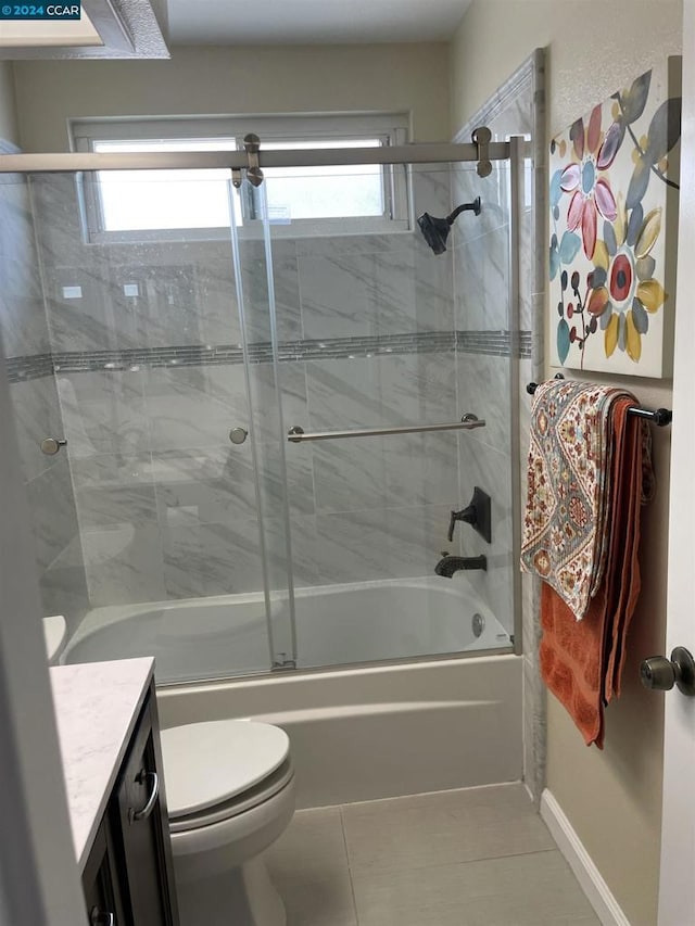 full bathroom featuring tile patterned floors, vanity, toilet, and a wealth of natural light