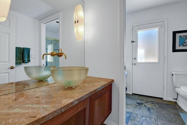 bathroom featuring toilet and vanity