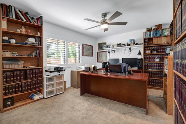 office area featuring light carpet and ceiling fan