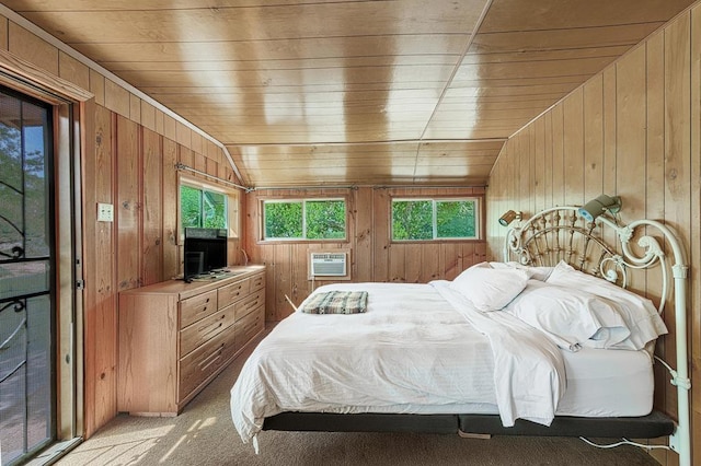 carpeted bedroom with wooden walls, wooden ceiling, and vaulted ceiling