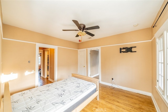 bedroom with wood-type flooring and ceiling fan