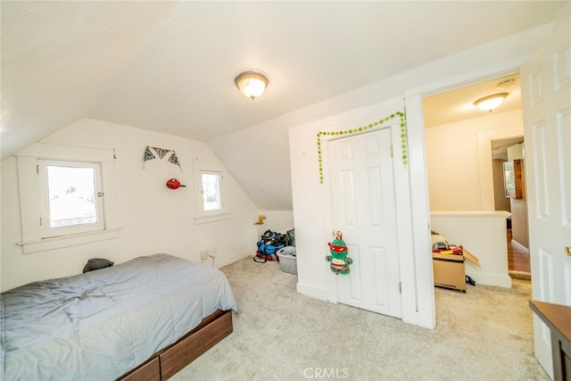 carpeted bedroom with vaulted ceiling