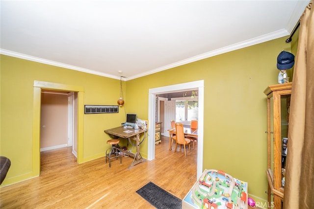 interior space with light wood-type flooring and crown molding