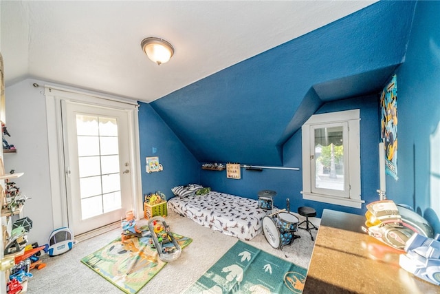 recreation room with vaulted ceiling, a textured ceiling, and carpet flooring