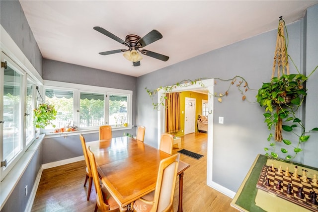 dining room with hardwood / wood-style floors and ceiling fan