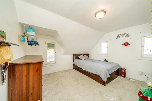 carpeted bedroom with vaulted ceiling