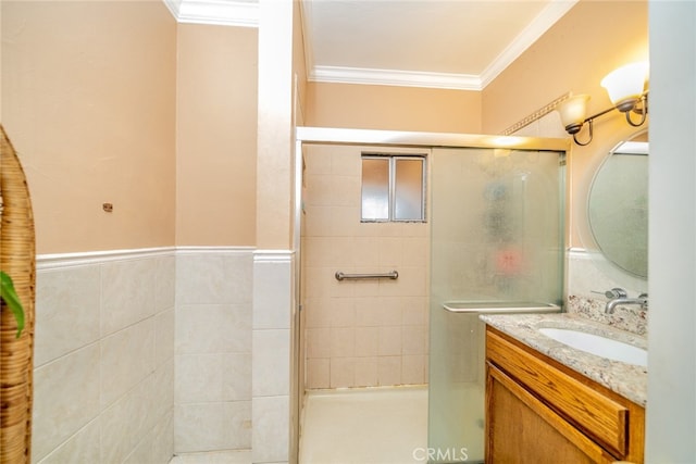 bathroom featuring crown molding, vanity, and a shower with door