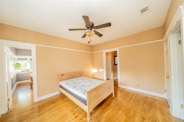 bedroom with hardwood / wood-style floors and ceiling fan