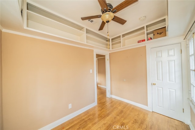 unfurnished bedroom with ceiling fan, ornamental molding, and light hardwood / wood-style floors