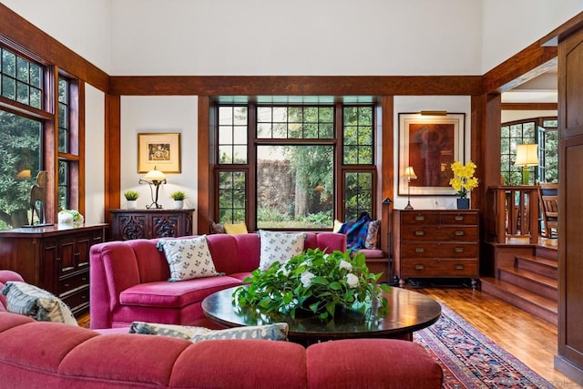 living room featuring a towering ceiling and light hardwood / wood-style floors