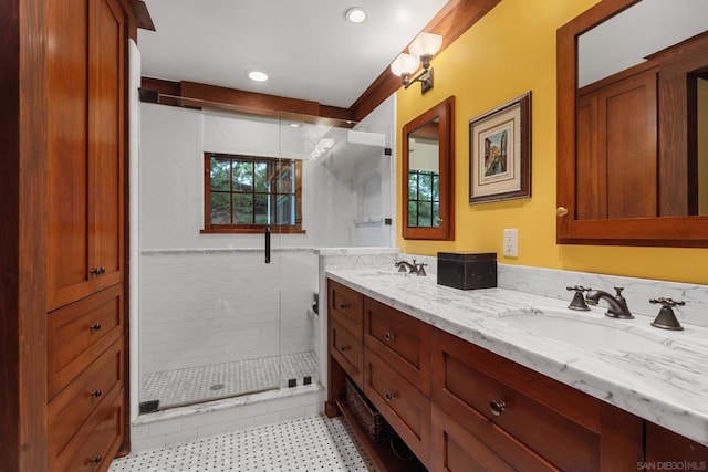 bathroom with a shower with shower door and vanity