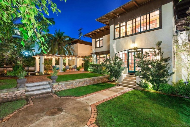 yard at twilight featuring a patio area