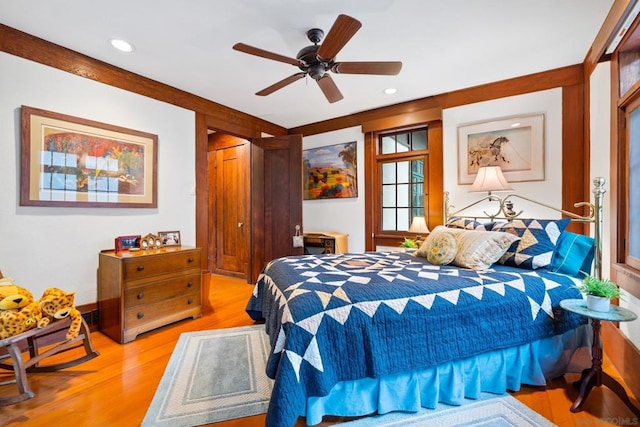 bedroom with ceiling fan, a closet, and light hardwood / wood-style flooring