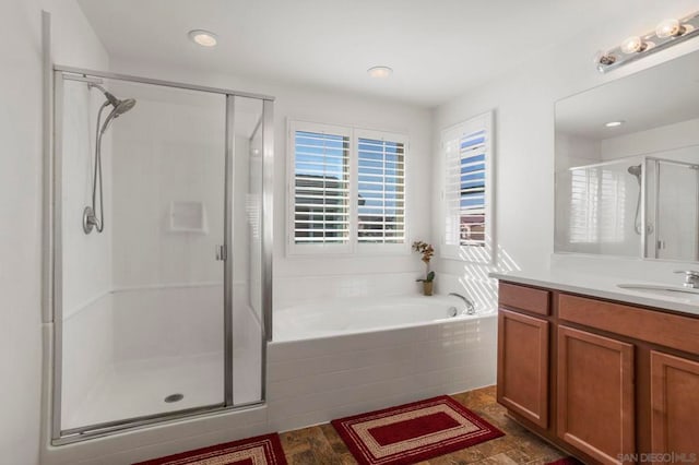 bathroom with vanity and independent shower and bath