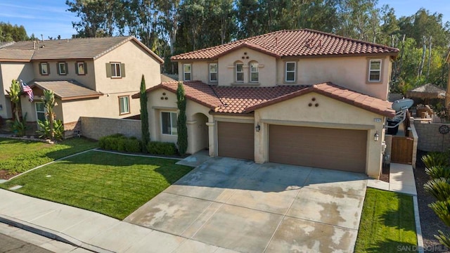 mediterranean / spanish-style home with a front lawn and a garage