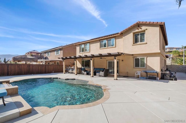 rear view of property with a patio area, a fenced in pool, and an outdoor living space