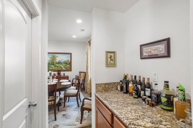 bar featuring light stone countertops