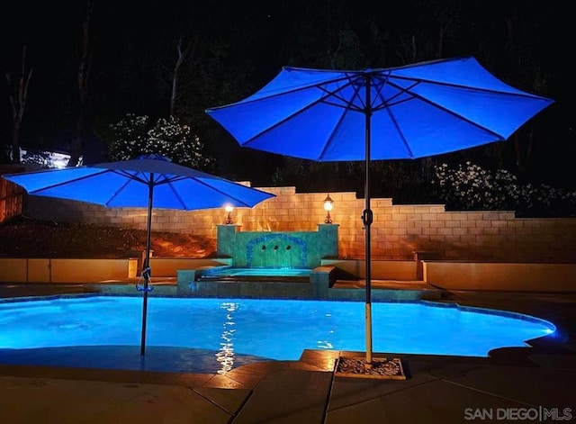 view of swimming pool with a patio area and a jacuzzi