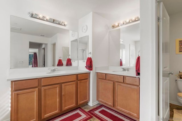 bathroom featuring vanity and toilet