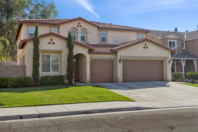 mediterranean / spanish-style home featuring a front yard and a garage