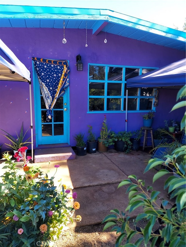 doorway to property with a patio area