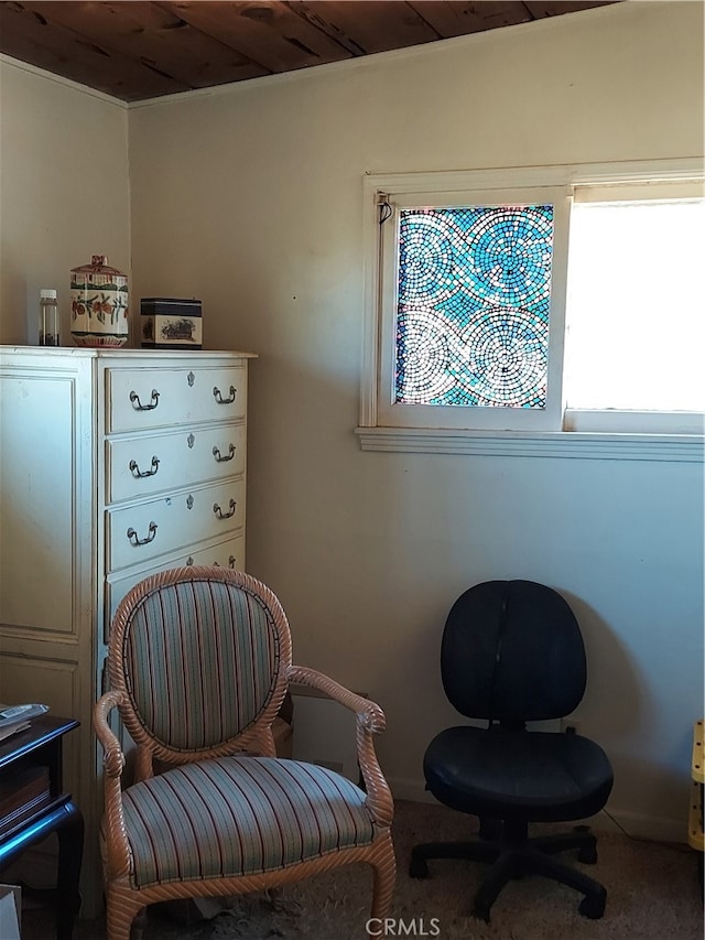 sitting room featuring carpet floors and wooden ceiling