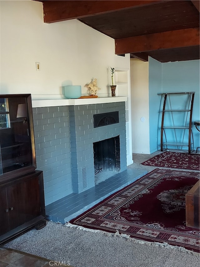 living room with beamed ceiling and a fireplace