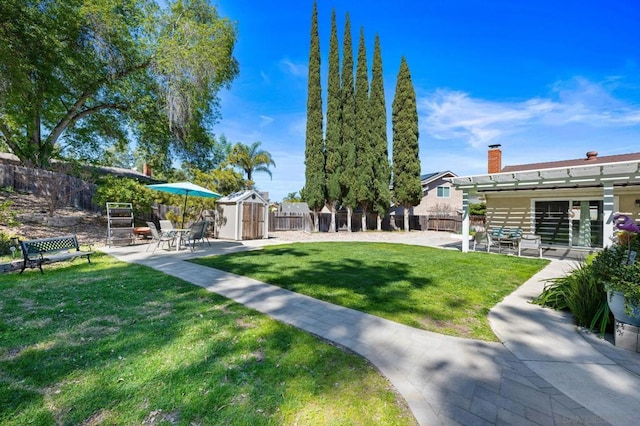 view of yard with a pergola, a shed, and a patio area