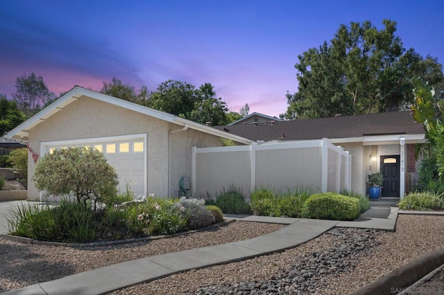 property exterior at dusk featuring a garage