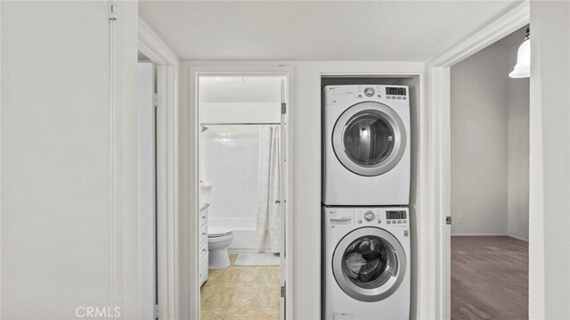 laundry room with stacked washer / dryer