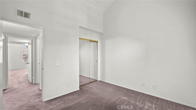 unfurnished bedroom featuring carpet floors and a closet