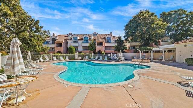 view of swimming pool with a patio