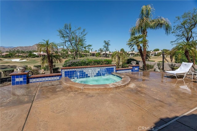 view of swimming pool with pool water feature, a mountain view, and a hot tub